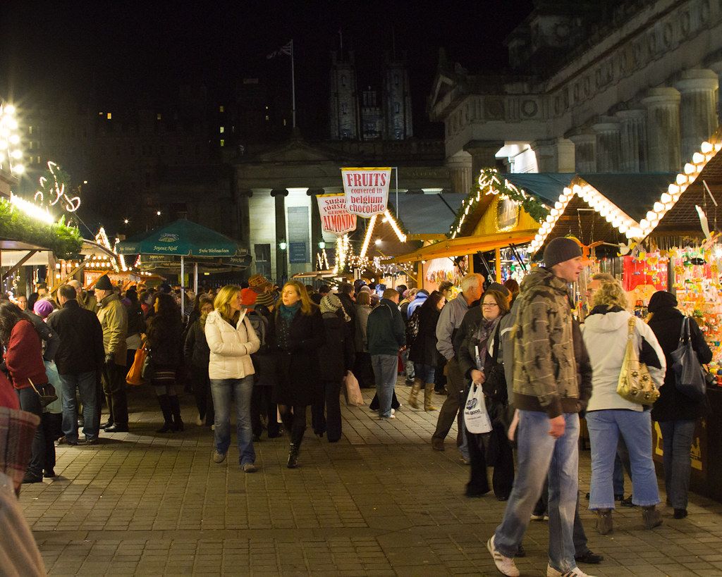 Edinburgh chrsitmas market stall with crowds dressed up warm